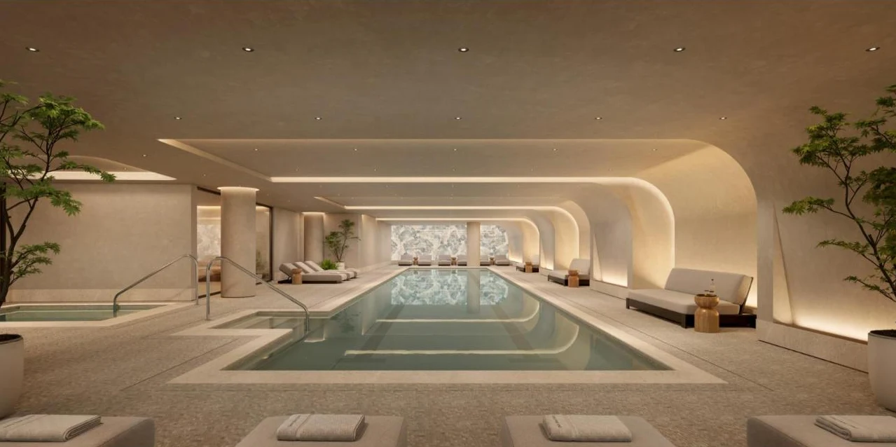 Rendering of a softly lit indoor lap pool with arched ceilings, lounge chairs and a hot spa