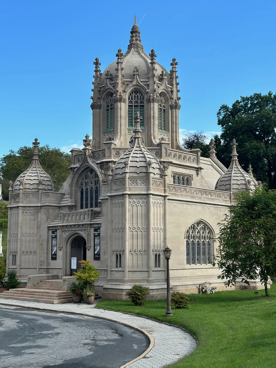 Green-Wood Cemetery’s ornate Gothic stone chapel with a domed central tower, pinnacles and stained-glass windows